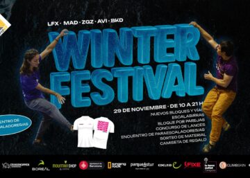 Dos personas escalando en un muro de escalada con el texto "Winter Festival" en grand